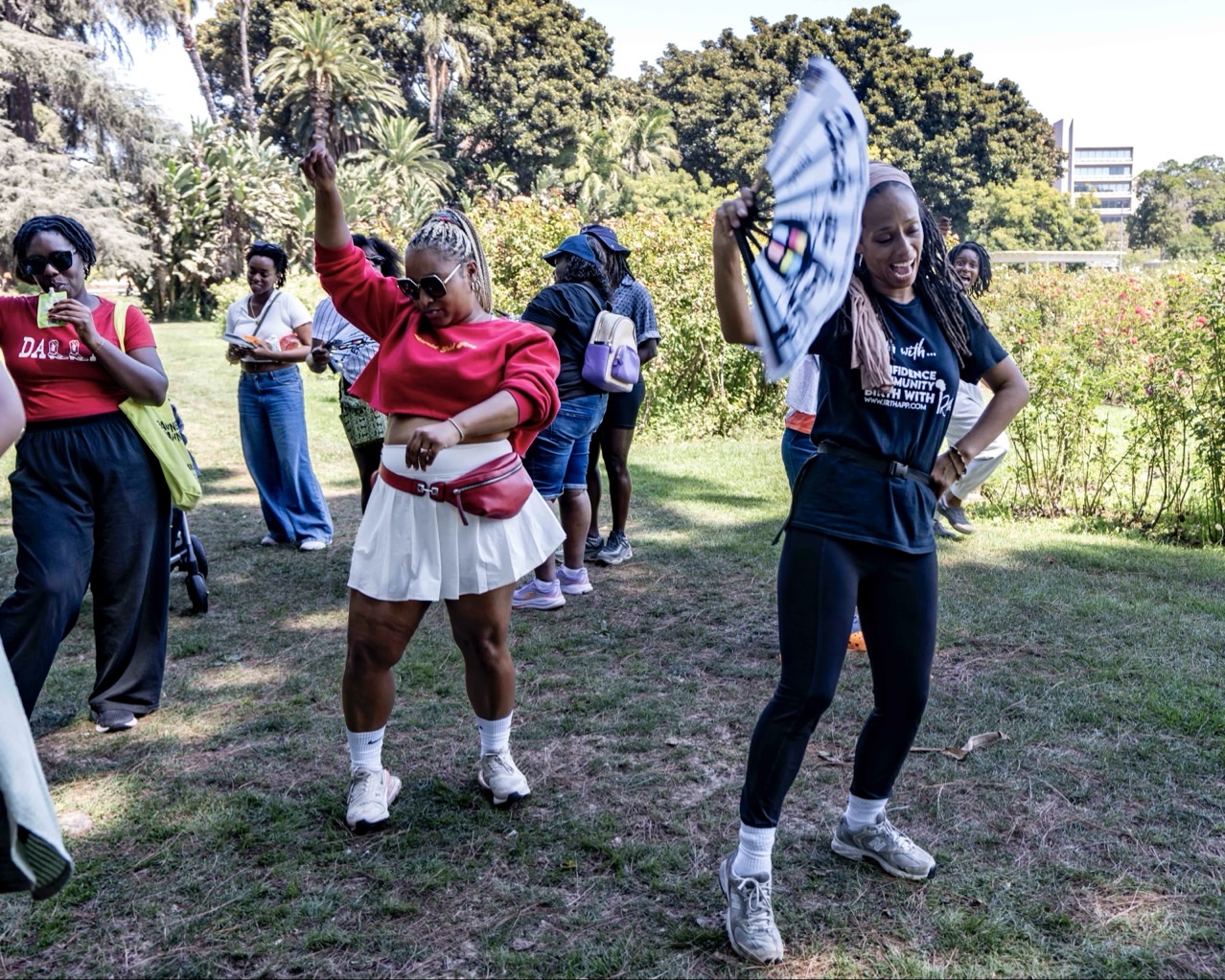 Ambassadors dancing together at an outdoor community event